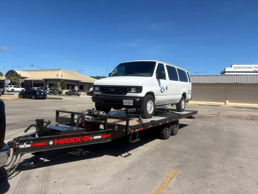 Passenger van on a Dirty~Max flatbed trailer, Guam