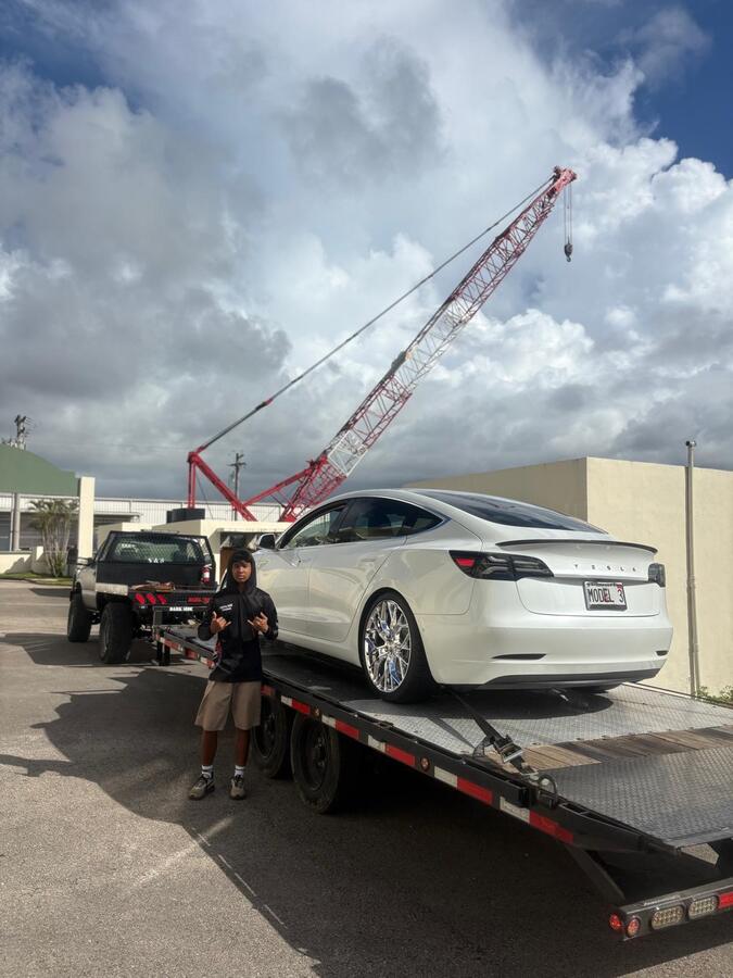Low Tesla Model 3 loaded on Dirty~Max flatbed