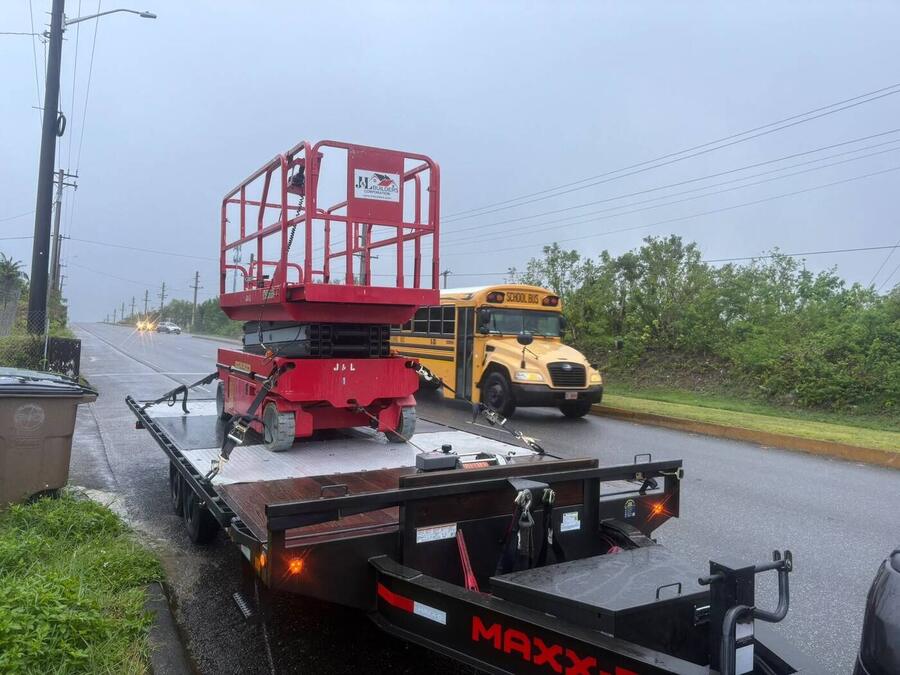 Scissor lift secured for transport on Guam road